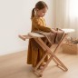 Preview: Kind bügelt Kleidung auf Holz Bügelbrett im Kinderzimmer