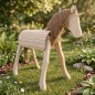 Preview: Holzpferd mit Einhorn-Horn steht im Garten – natürliche Integration für fantasievolles Spielen im Freien