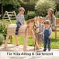 Preview: Mehrere Kinder entdecken gemeinsam den Holzesel PEDRO im Garten – ideal für Kita und Familien.