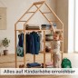 Preview: Kind erreicht Kleidung am Montessori Kleiderschrank selbstständig im hellen Flur