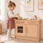 Preview: Kind spielt an Holz Kinderküche für Kita in Weiß-Natur mit Herd, Spüle und Metallgriffen