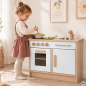 Preview: Kind spielt an Holz Kinderküche für Kita in Weiß-Natur mit Herd, Spüle und Metallgriffen