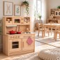 Preview: Holz Kinderküche GRETEL aus massiver Buche natur im hellen skandinavischen Kinderzimmer mit Holzmöbeln und Pflanzen.