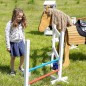Preview: Kind springt mit Hobbyhorse über die Kinder Springhürde aus Holz im Garten