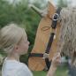 Preview: Kind legt dem Holzpferd Einhorn ein Halfter um Preview: Kind legt dem Holzpferd Einhorn ein Halfter um