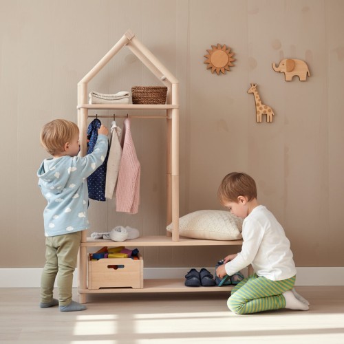 Preview: Montessori Garderobe mit Sitzbank und Stange aus Buchenholz Natur Preview: Montessori Garderobe im skandinavischen Stil, Kind (4-5 Jahre) hängt selbstständig eine Jacke auf.