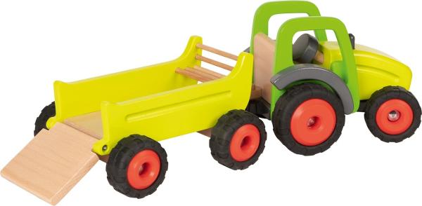 Traktor lädt etwas vom Anhänger ab Traktor lädt etwas vom Anhänger ab